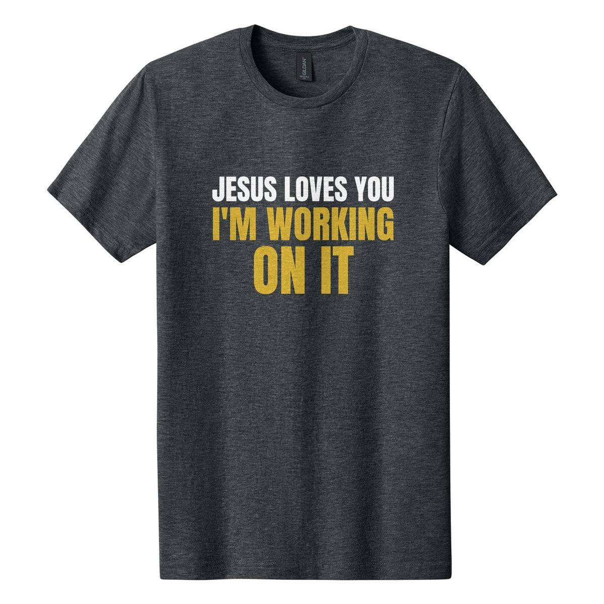 Jesus Loves You. I'm Working on It tee in Dark Heather, Anton font, White + Metallic Gold ink
