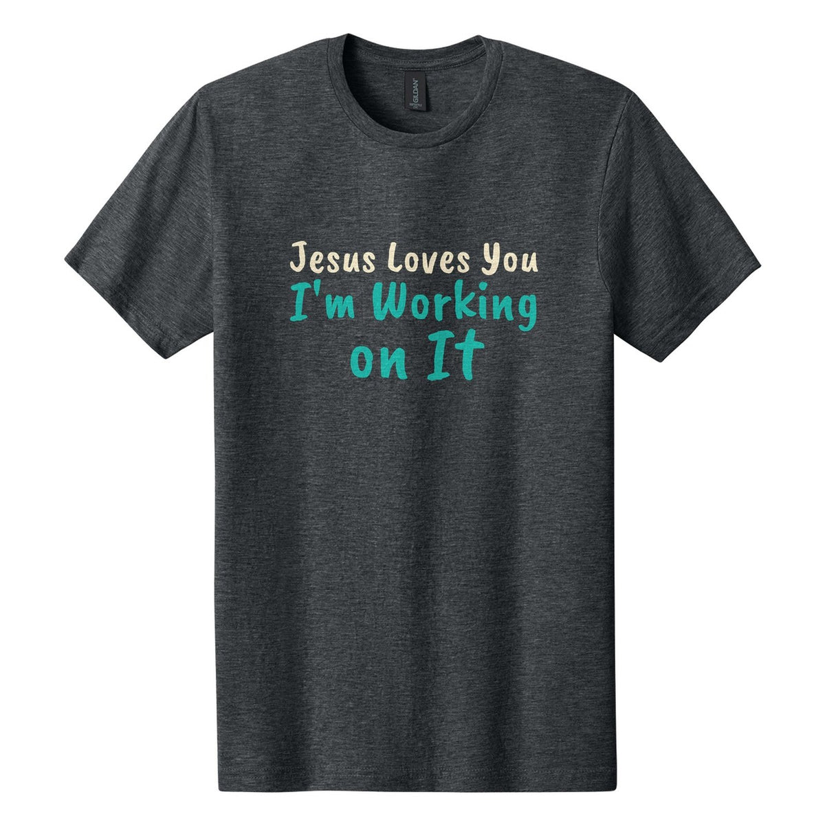 Jesus Loves You. I'm Working on It tee in Dark Heather, Caveat Brush font, Cream + Teal ink