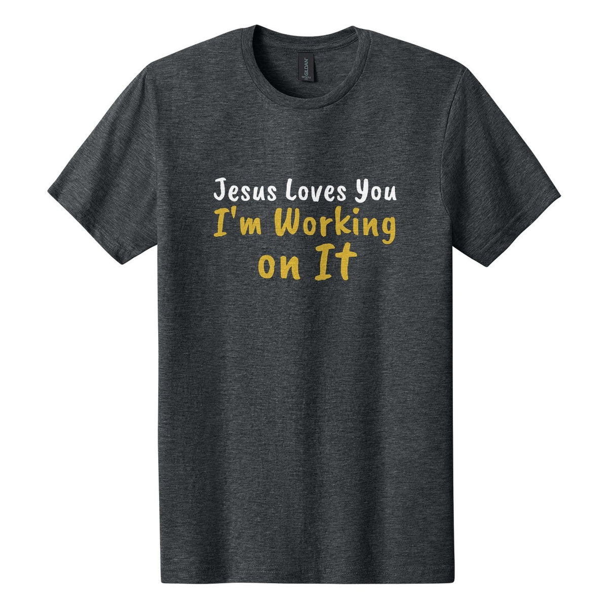 Jesus Loves You. I'm Working on It tee in Dark Heather, Caveat Brush font, White + Metallic Gold ink