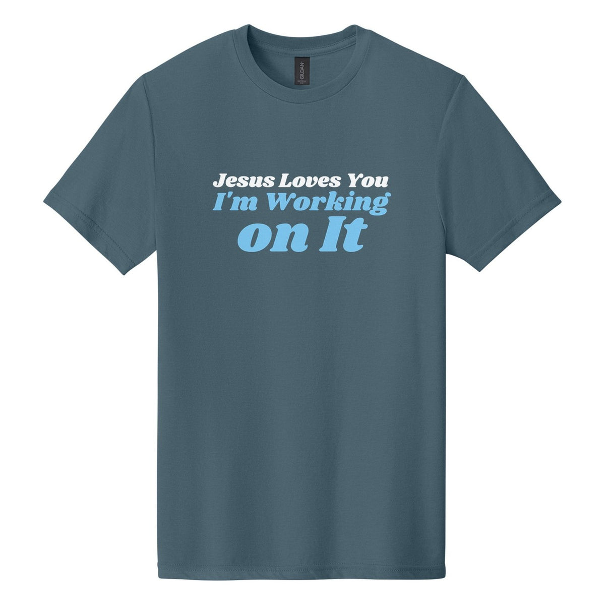 Jesus Loves You. I'm Working on It tee in Steel Blue, Shrikhand font, White + Sky Blue ink