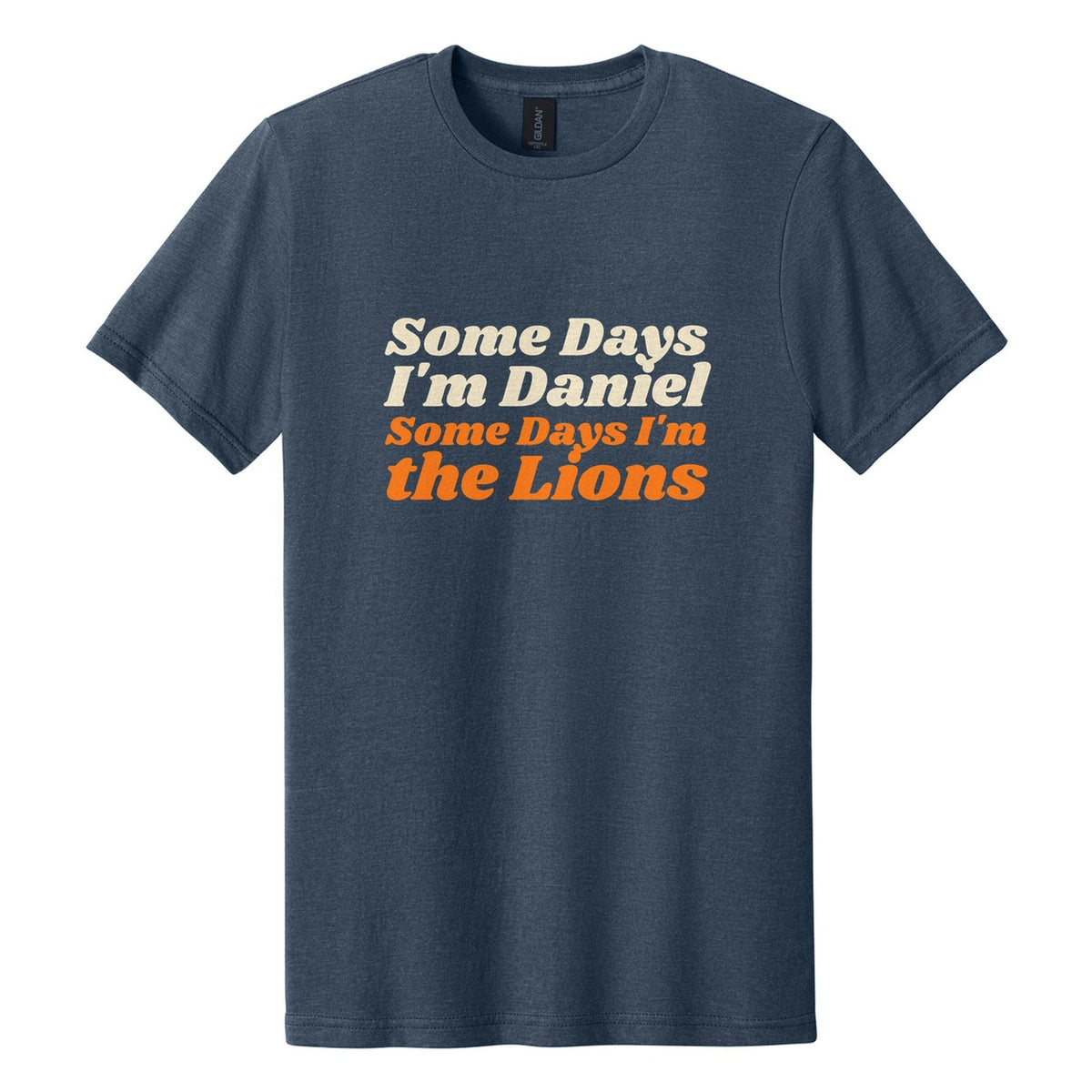 Some Days I'm Daniel. Some Days I'm the Lions tee in Navy Mist, Shrikhand font, Cream + Orange ink
