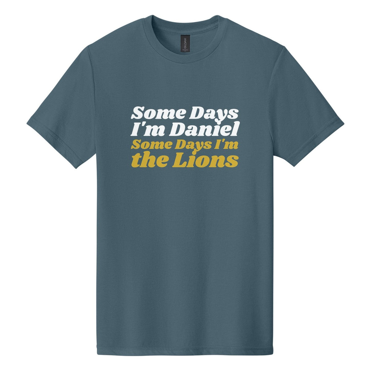 Some Days I'm Daniel. Some Days I'm the Lions tee in Steel Blue, Shrikhand font, White + Metallic Gold ink